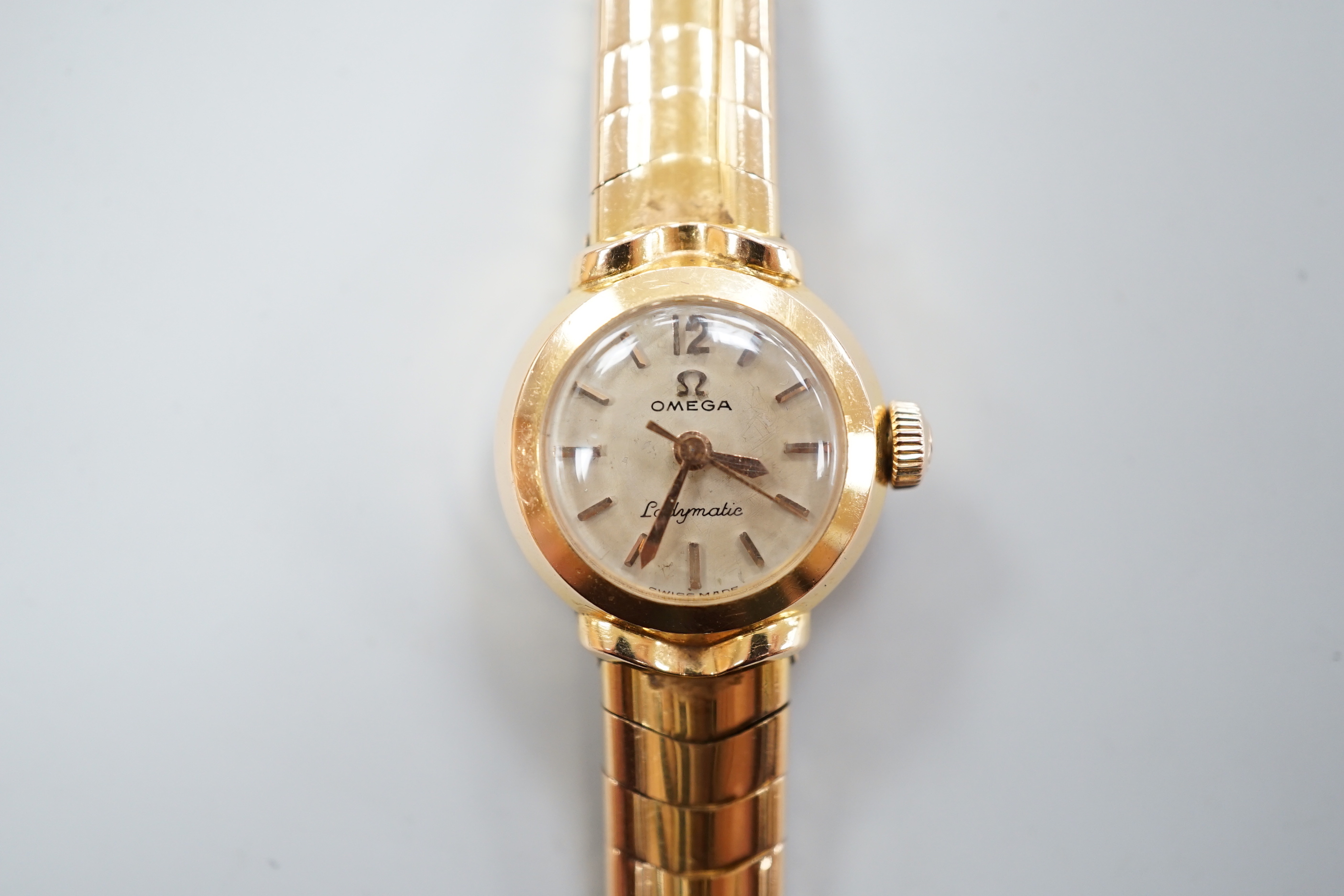 A lady's yellow metal, stamped 750, Omega Ladymatic wrist watch, on a 750 bracelet, length 17.cm, gross weight 38.9 grams.